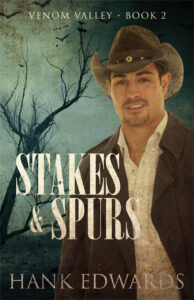 Stakes & Spurs Venom Valley Book Two cover. Handsome cowboy smiling at the camera. Dead tree with bats in the background in front of a blue green sky.